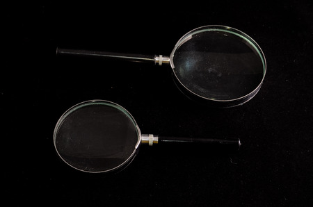 Vintage Magnify Glass Loupe on a Black Backgroundの写真素材