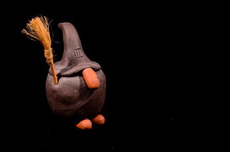 Clay Handmade Statue of a Witch on Black Backgroundの写真素材