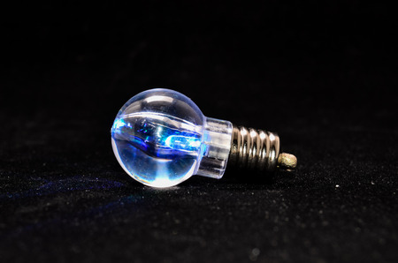 Photo of an Illuminated Light Bulb on Black Backgroundの写真素材