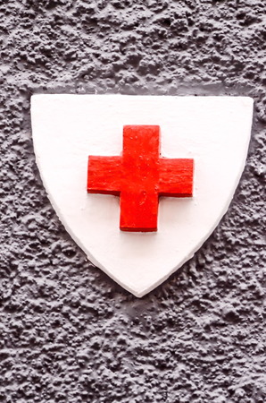 Red Cross Medical Sign Over a White Backgroundの写真素材