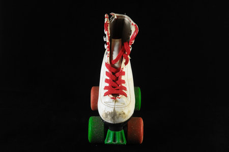 Used Vintage Consumed Roller Skate on a Black 