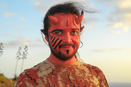 Latin American Man with Long Hairs Masked as a Devil in the Desert