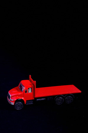 Red Toy Figurine Truck on a Black Backgroundの写真素材