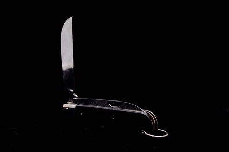 Vintage Black Knife Tool on a Dark Background