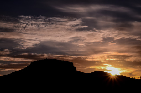 Sun behind a Mountain Silhouette in Gran Canaria Spainの写真素材