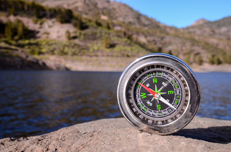 Orientation Concept - Analogic Compass Abandoned on the Rocksの写真素材