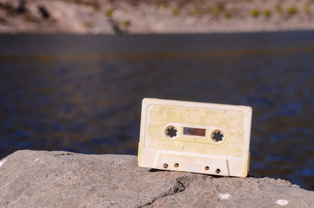 Ancient Retro Musicassette on the Rock into the Wildの写真素材