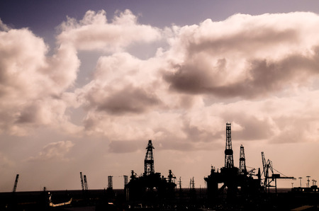 Oil Drilling Rig Silhouette over a Cloudy Skyの写真素材