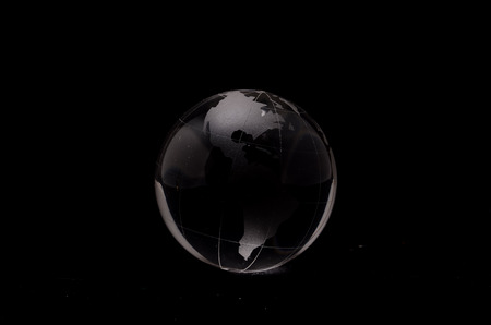 Glass Transparent Globe Earth on a Black Backgroundの写真素材