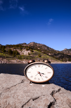 Time Concept Classic Vintage Pocket Clock on the Volcanic Rocksの写真素材