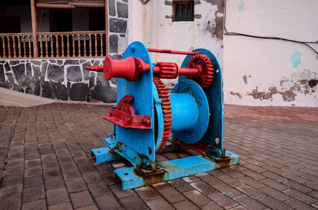 Old Vintage Metal Winch in a Port Harbor