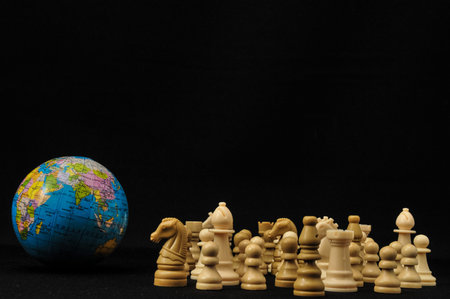 Globe And White Chess on a Black Background