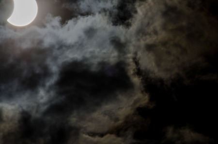 Partial Solar Eclipse on a Cloudy Dayの写真素材