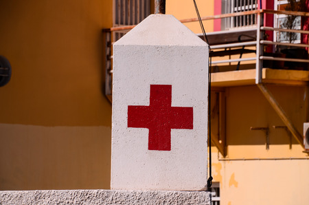 Red Cross Medical Sign Over a White Backgroundの写真素材