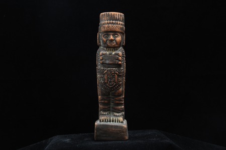 One Ancient Mayan Statue on a Black Backgroundの写真素材