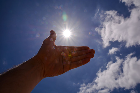 Picture of an Hand over the Sky and Sunの写真素材