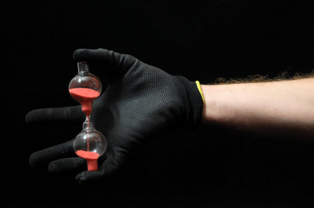 Clock And an Hand on a Black Background