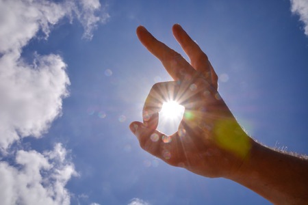 Picture of an Hand over the Sky and Sunの写真素材