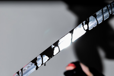 Sharp Katana Sword Blade Dripping Black Color Paintingの写真素材