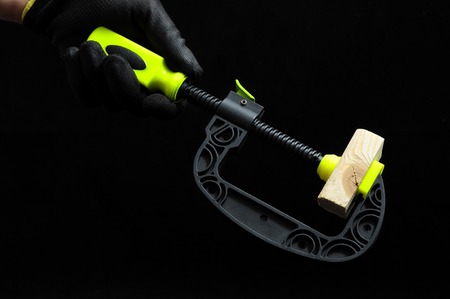 Pliers and a Hand on a Black Backgroundの写真素材