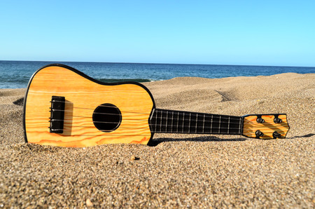 Photo Picture of a Guitar on the Sand Beachの写真素材