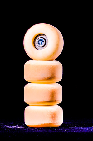 Old Vintage Consumed Skate Wheel on a Black Backgroundの写真素材