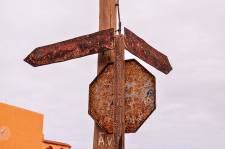 Vintage Old Rusty Road Sign Consumed by the Timeの写真素材