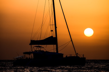 Photo Picture of a Sail Boat Silhouette  at Sunsetの写真素材