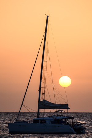 Photo Picture of a Sail Boat Silhouette  at Sunsetの写真素材