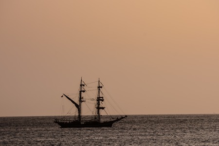 Photo Picture of a Sail Boat Silhouette  at Sunsetの写真素材