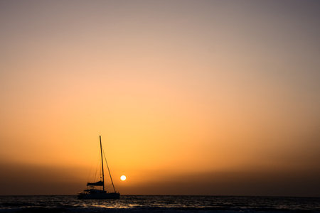 Photo Picture of a Sail Boat Silhouette  at Sunsetの写真素材
