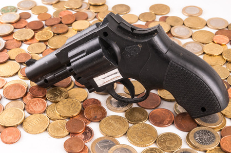 Picture of a Business Money Concept Idea Coins and Gunの写真素材