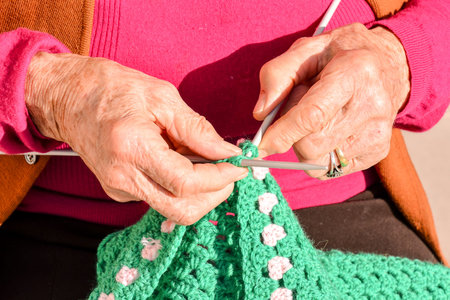 Close-up image of an old woman with knitting needles and woolの写真素材
