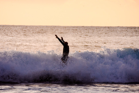 Single surfer at sunset on a calm oceanの写真素材