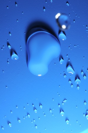 Some Water Drops on a Blue Textured Backgroundの写真素材