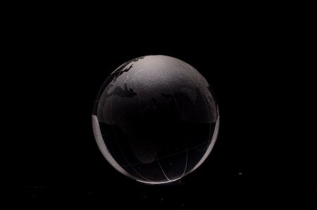 Glass Transparent Globe Earth on a Black Backgroundの写真素材