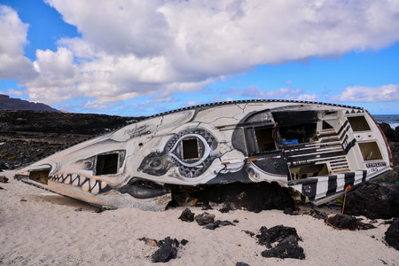 Sailboat stranded on the beach after a stormの写真素材