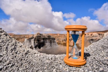 Conceptual Photo Picture of an Hourglass Object in the Dry Desert