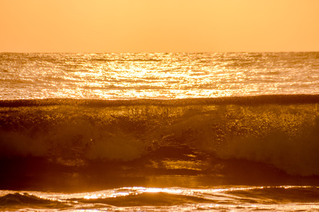Single surfer at sunset on a calm oceanの写真素材
