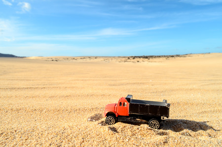 Conceptual Photo Picture of a toy car in the dry desertの写真素材