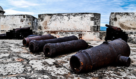 Old Rusty Unused Guns over the Rooftop in Cubaの写真素材