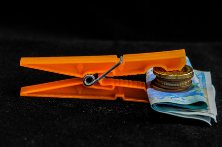 Orange clip with money on a black backgroundの写真素材
