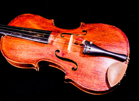 Classical shape wood vintage violin Music instrument isolated on Black backgroundの写真素材