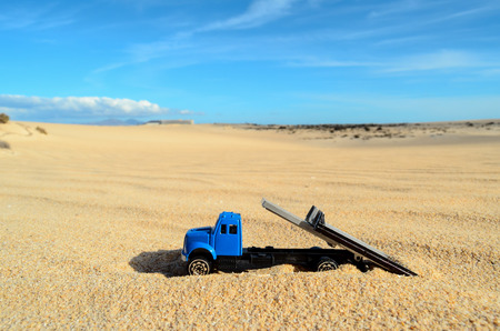 Conceptual Photo Picture of a toy car in the dry desertの写真素材