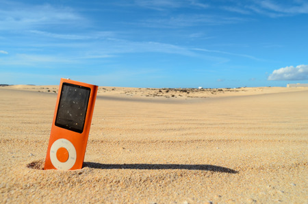 Conceptual Photo Picture of a Music Player Object in the Dry Desertの写真素材