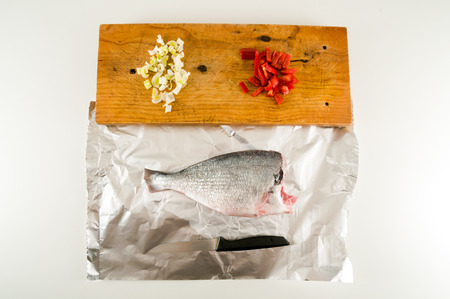 Fresh dorada fish decorated sea bream ready to be cookedの写真素材
