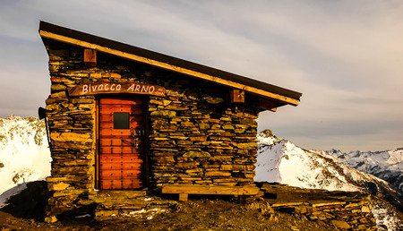 italian bivouac on a top of a mountain in winter with snowの写真素材