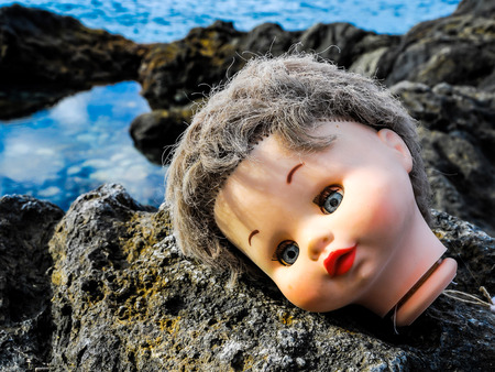 One Ancient Dool's Head Abandoned on the Rocksの写真素材