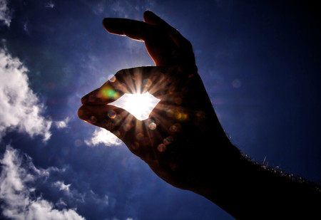 Picture of an Hand over a Cloudy Skyの写真素材