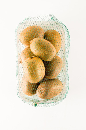 Kiwi in a box isolated on white backgroundの写真素材